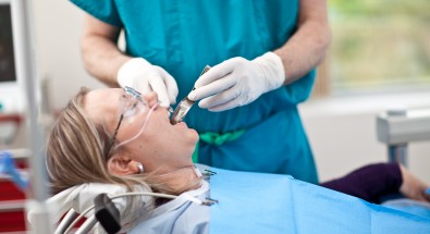Close up of patient getting her teeth checked at Pacific Coast Oral and Maxillofacial Solutions