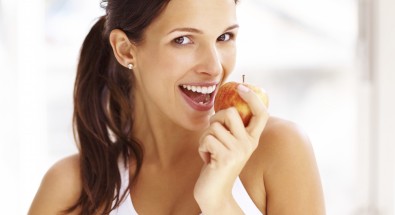 Woman about to bite into apple