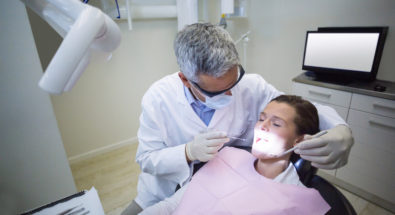Oral Surgeon performing safety check on patients teeth